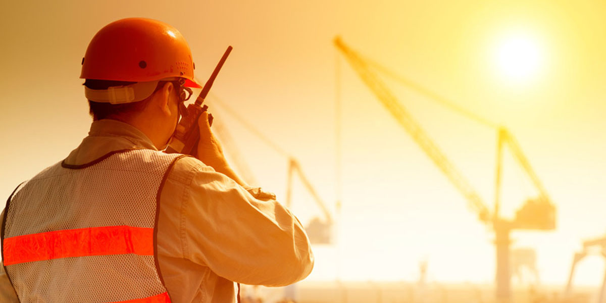 Construction worker on crane site on a hot day